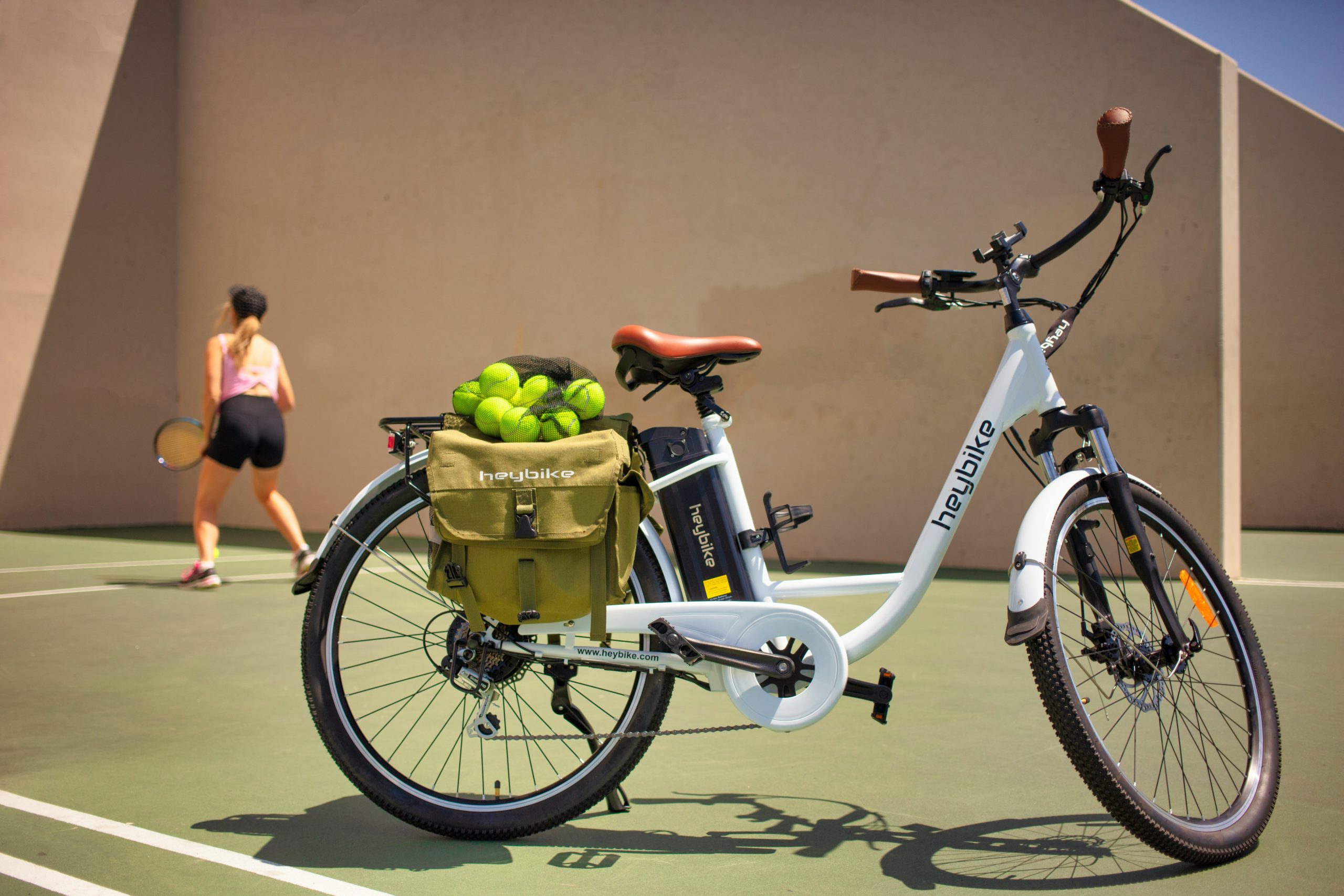 a low step-through electric bike parked on a tennis court