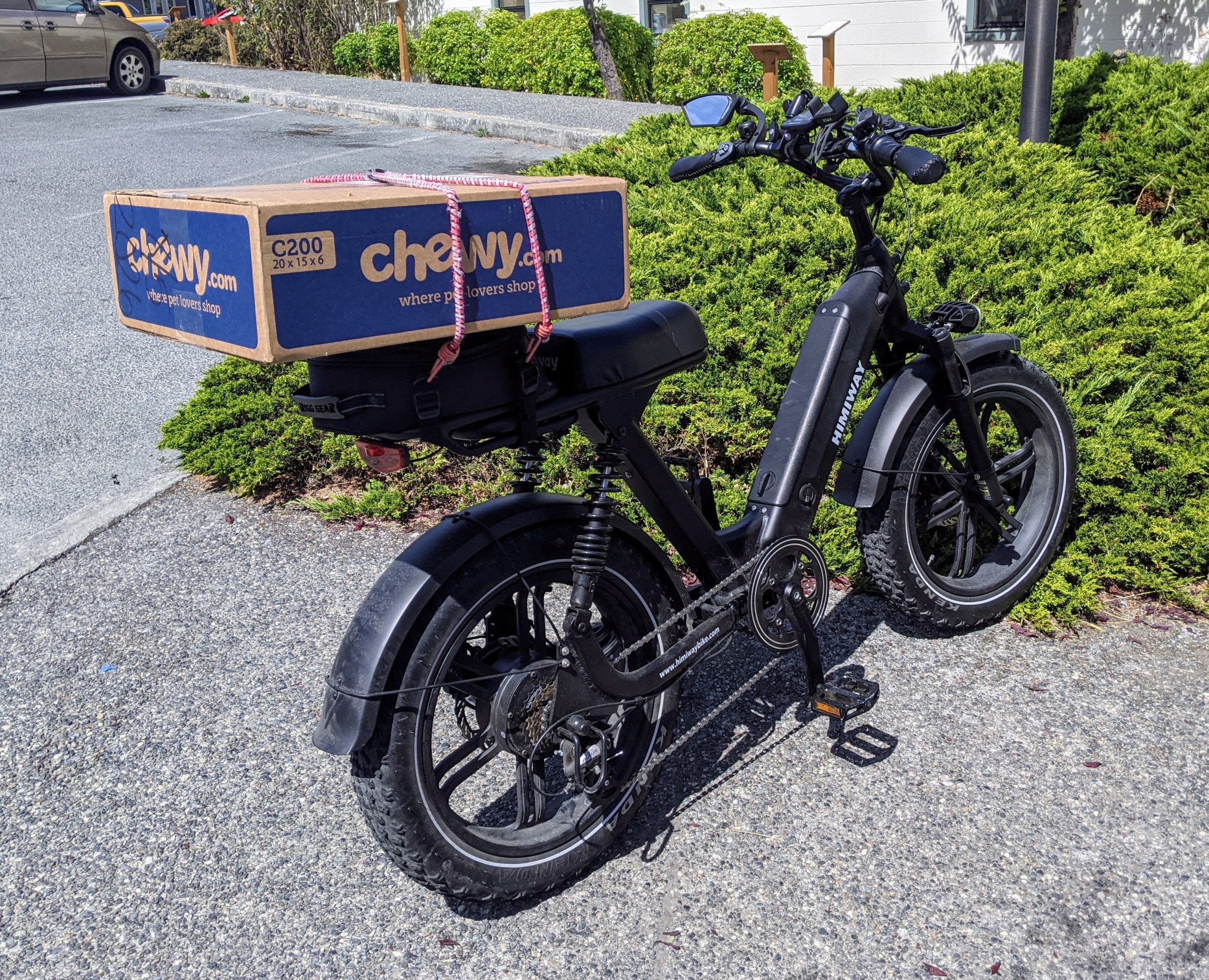 electric bike bike with a cardboard box on the rear cargo rack