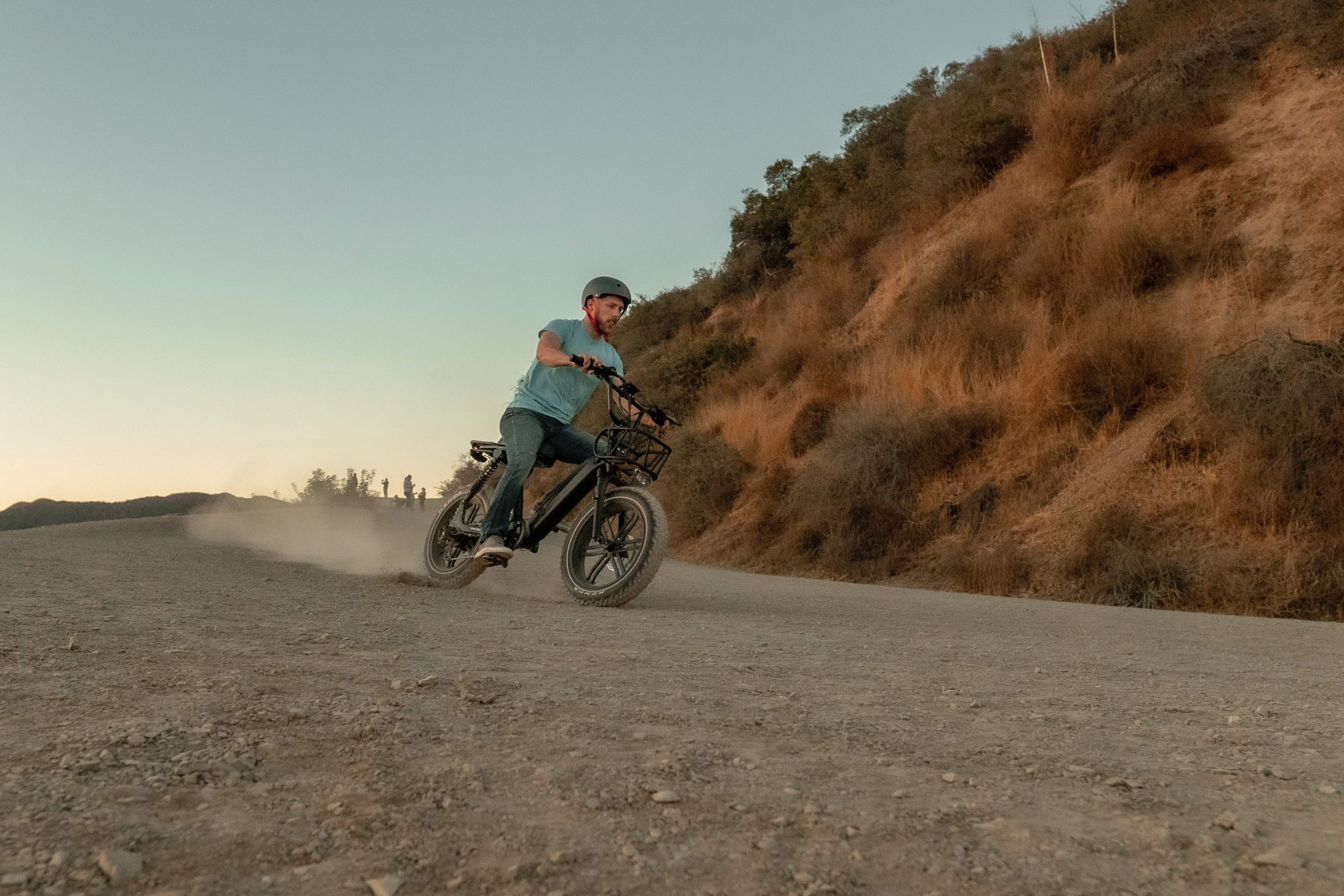 man on an electric bike going fast down a steep dirt road